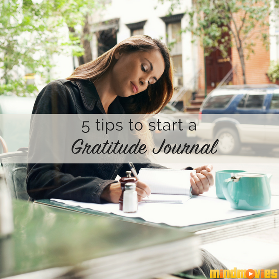 woman writing in gratitude journal
